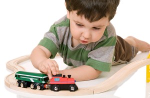 boy playing with a train set