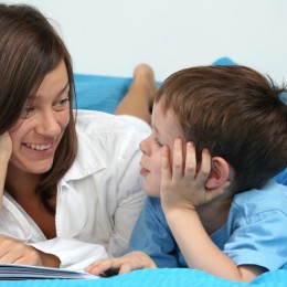 mother and five years old boy reading book - good night